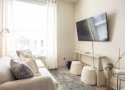 Thumbnail 24 of 47 - a living room with a couch and a tv
