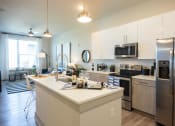Thumbnail 14 of 47 - a kitchen with stainless steel appliances and a white counter top