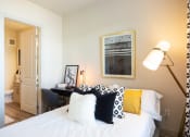 Thumbnail 17 of 47 - a bedroom with a bed with black and white pillows