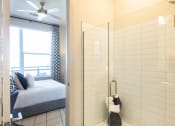 Thumbnail 19 of 47 - a room with a mirror and a bed and a window