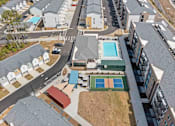 Thumbnail 29 of 29 - A bird's eye view of a residential area with a tennis court and a swimming pool.