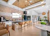 Thumbnail 19 of 29 - A modern kitchen with a dining table and chairs.