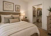 Thumbnail 12 of 40 - A bedroom with a large bed and a wardrobe.