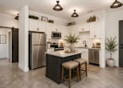 Thumbnail 8 of 33 - A modern kitchen with a center island and stainless steel appliances.