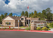 Thumbnail 35 of 42 - the front of a building with a sign and an flag
