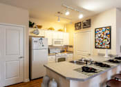 Thumbnail 7 of 25 - A kitchen with a white fridge and a white door.