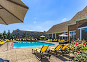 Thumbnail 17 of 25 - A pool surrounded by yellow chairs and umbrellas.