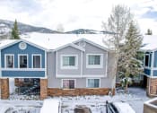 Thumbnail 36 of 43 - a blue house with a snowy mountain in the background