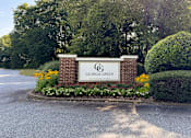 Thumbnail 16 of 23 - A sign that says "Georgia Green" is surrounded by flowers and greenery.