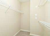 Thumbnail 22 of 44 - A small, empty room with a carpeted floor and two shelves.