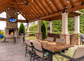 Thumbnail 14 of 34 - Pool Side Cabana with Tv and Wood Burning Fireplace