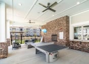 Thumbnail 26 of 35 - the preserve at ballantyne commons clubhouse with ping pong table and brick fireplace