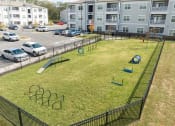 Thumbnail 23 of 35 - a playground in an apartment complex with cars parked in a parking lot