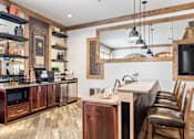 Thumbnail 5 of 44 - A kitchen with wooden cabinets and a large mirror on the wall.