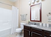 Thumbnail 21 of 44 - A bathroom with a toilet, sink, and shower.
