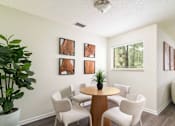 Thumbnail 7 of 35 - A room with a table and chairs and pictures on the wall.