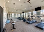 Thumbnail 9 of 33 - a gym with exercise equipment and windows in a building at Orion Prosper, Prosper, TX, 75078