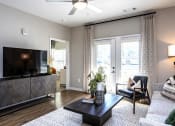 Thumbnail 5 of 35 - a living room with sliding glass doors and a tv