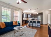 Thumbnail 13 of 36 - Greenville, SC Pet-Friendly Apartments - Velo Verdae - Living Room with Wood-Style Flooring, an Open Layout, and Kitchen Area