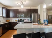 Thumbnail 10 of 36 - full kitchen with granite counter tops and stainless steel appliances