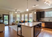 Thumbnail 12 of 36 - an open kitchen and living room with a large counter top