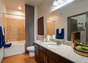 Thumbnail 18 of 36 - a bathroom with a sink and a toilet and a shower