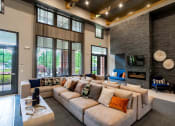 Thumbnail 4 of 36 - Three-BR Apartments in Greenville, SC - Vela Verdae - Clubhouse with High Ceilings, Seating Area, and Fireplace