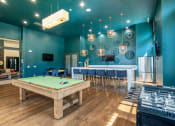 Thumbnail 5 of 36 - a game room with a pool table and a bar