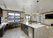Thumbnail 17 of 31 - A modern kitchen with a pool table.