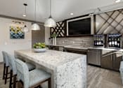 Thumbnail 16 of 31 - A kitchen with a marble countertop and a large island.