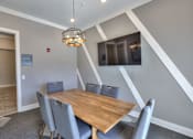 Thumbnail 22 of 31 - A dining room with a wooden table and grey chairs.