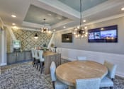 Thumbnail 21 of 31 - A modern dining room with a wooden table and grey chairs.