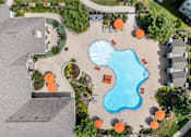 Thumbnail 24 of 31 - an overhead view of a swimming pool in a garden with tables and umbrellas