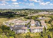 Thumbnail 29 of 31 - an aerial view of an apartment complex with a city in the background