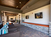 Thumbnail 20 of 31 - a lobby with couches and a television on the wall