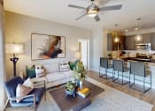 Thumbnail 1 of 35 - a living room with a ceiling fan and a kitchen in the background