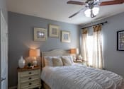 Thumbnail 10 of 28 - a bedroom with a bed and a ceiling fan
