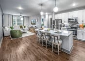 Thumbnail 16 of 48 - an open kitchen and living room with a large center island