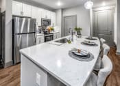 Thumbnail 17 of 48 - a kitchen with stainless steel appliances and a marble counter top