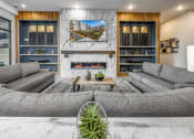 Thumbnail 4 of 48 - a living room with couches and a table and a fireplace