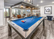 Thumbnail 10 of 48 - a billiards table in a clubhouse with a blue pool table