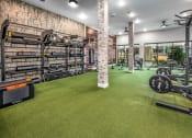 Thumbnail 8 of 48 - a home gym with weights and equipment and a brick wall