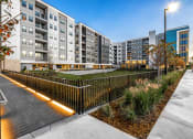 Thumbnail 14 of 48 - an outdoor courtyard with a fence and an apartment building