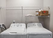 Thumbnail 7 of 31 - two washers and a dryer in a laundry room