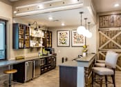 Thumbnail 16 of 31 - a large kitchen with a counter and a bar with chairs