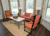 Thumbnail 4 of 23 - A living room with a sofa, chair, and coffee table.