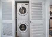 Thumbnail 25 of 78 - a small laundry room with a washing machine and a dryer at Altis Blue Lake, Lake Worth, FL, 33467
