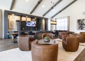 Thumbnail 3 of 21 - a large living room with leather furniture and a bar