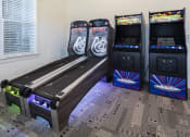 Thumbnail 11 of 21 - two arcade game machines in a room next to a window