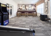 Thumbnail 6 of 21 - a room with a pool table and a video game